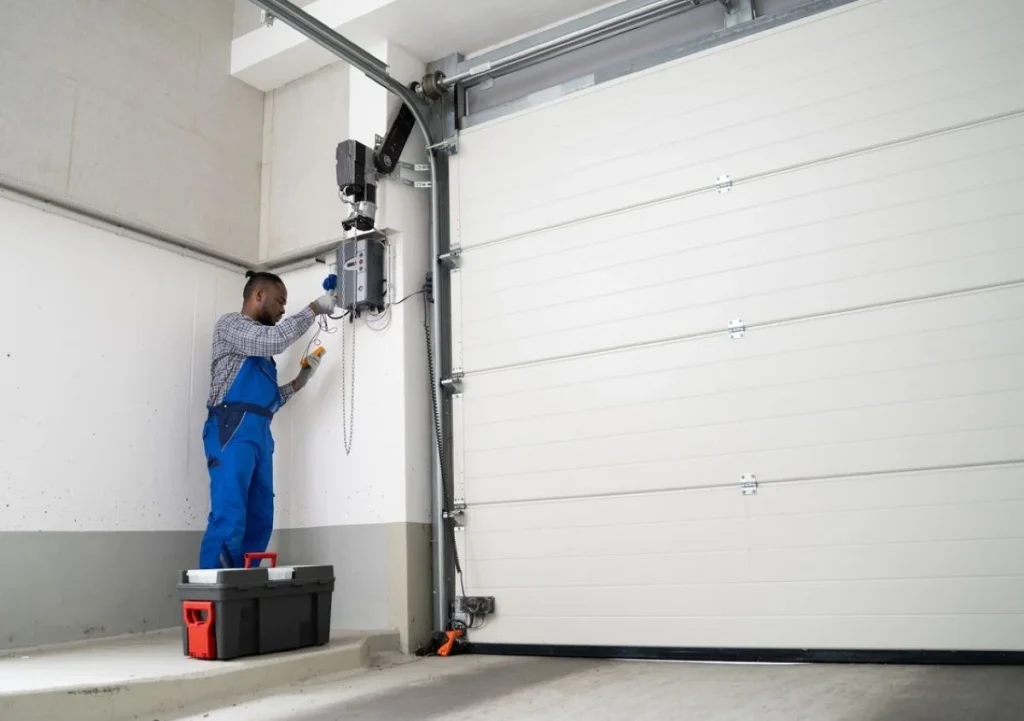 Tallahassee garage door technician repairing broken torsion spring safely.