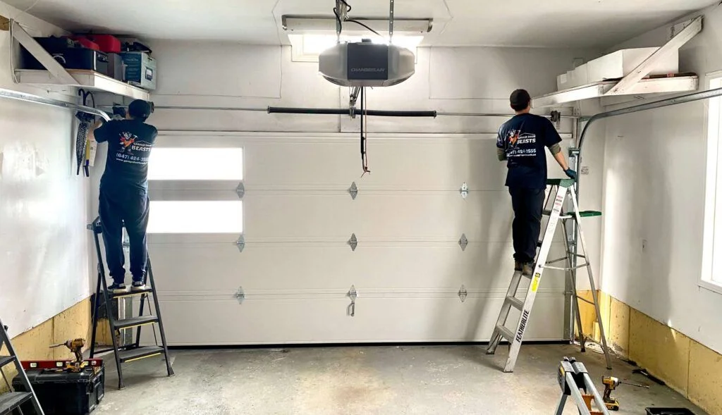 Technicians performing garage door repair in Tallahassee, fixing opener system with professional tools
